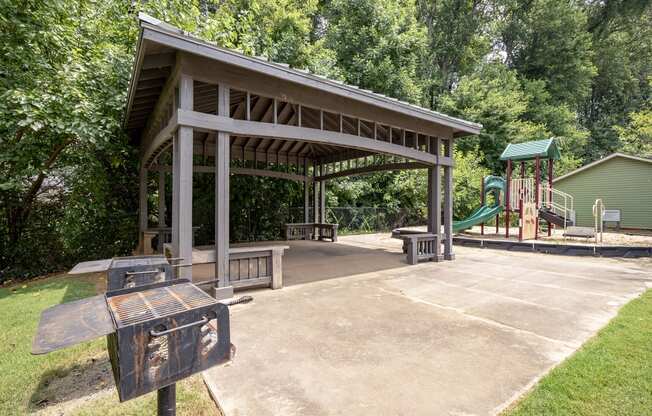 a pavilion with a playground in a park