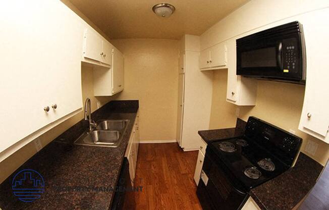 a kitchen with a sink and a stove and a microwave