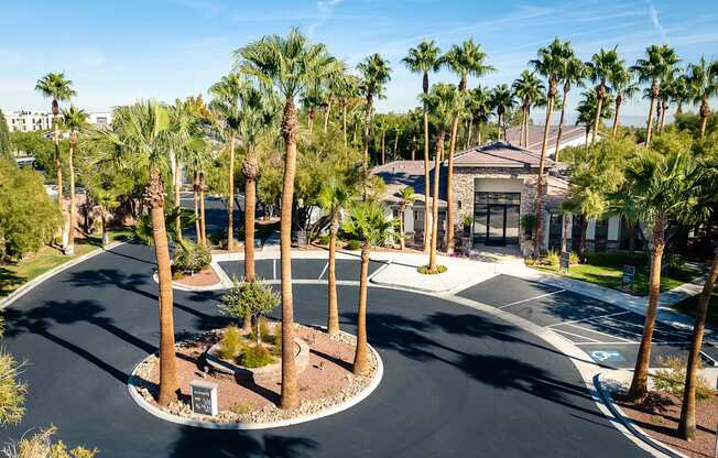 a roundabout with palm trees in front of a building