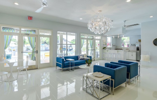 a living room filled with furniture and a large chandelier