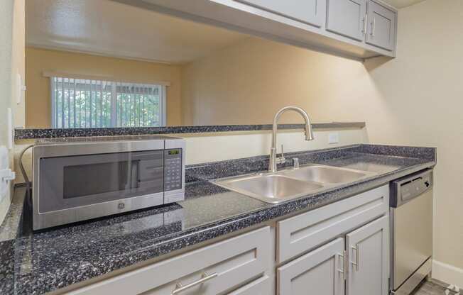 a kitchen with a sink and a microwave