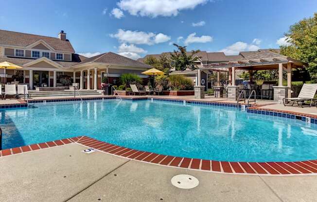 Large pool with seating and pergola
