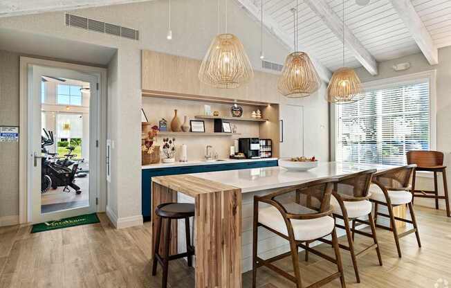 A kitchen with a bar area and a dining table.