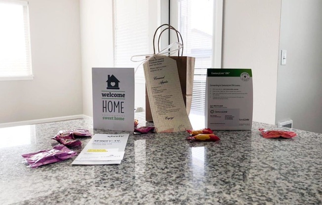 three bags sitting on a counter with some clothes on it