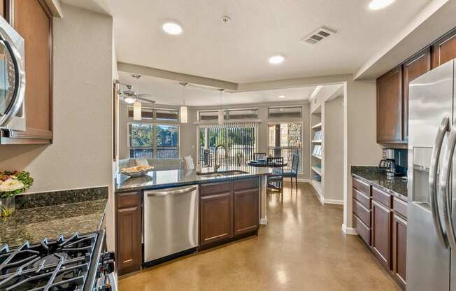 A modern kitchen with a large island and stainless steel appliances. at Bridge at Heritage Woods, Texas