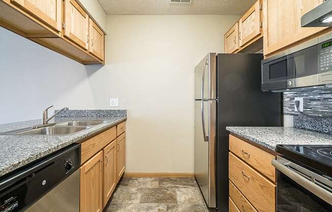 Galley style kitchen with stainless steel GE appliances at Skyline View Apartments in Lincoln NE