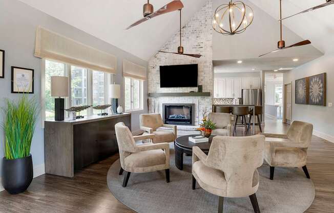 a living room with a fireplace and a table and chairs