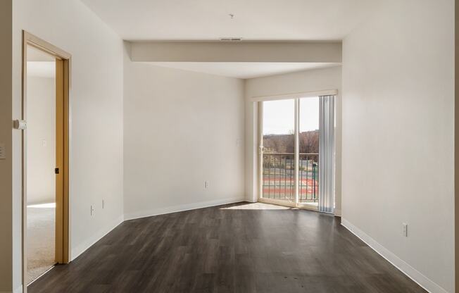 a spacious living room with white walls and sliding glass doors to the private balcony.at Shoreline Village, Richland, WA 99352