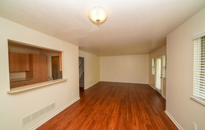 A dining room with hard surface floors and a window with blinds at Foxwood and The Hermitage, Portage, MI, 49024