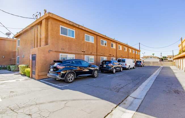 a large brick building with cars parked in front of it