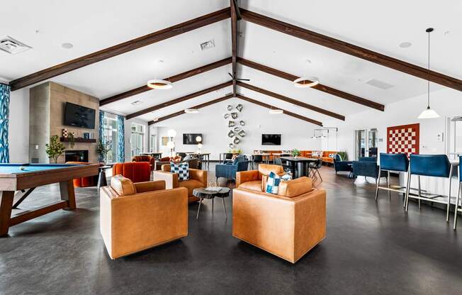 A room with a pool table and a couch.