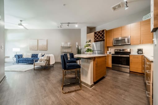 an open kitchen and living room with a table and chairs