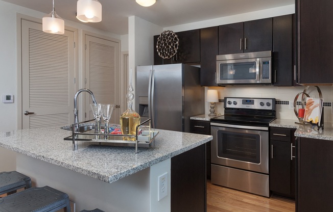 All kitchens feature stainless steel appliances and some include a breakfast bar.