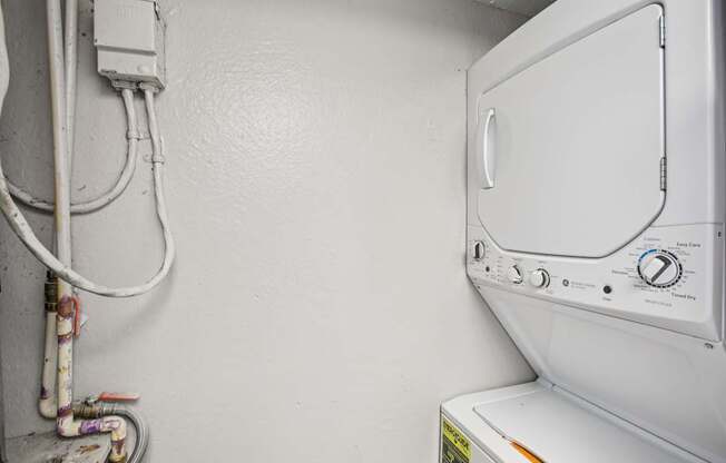 A white washing machine with a grey door and a yellow sticker on the front.