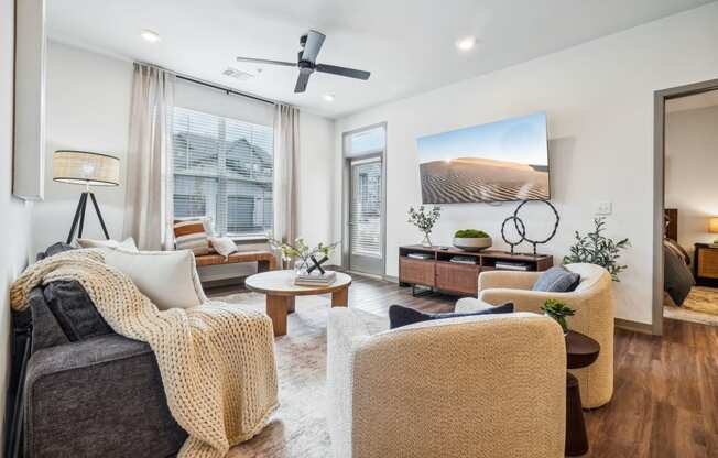 a living room with furniture and a ceiling fan