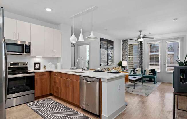 A modern kitchen with wooden cabinets and stainless steel appliances.