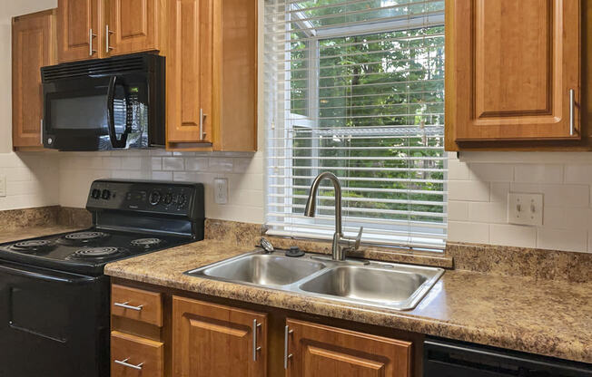 a kitchen with a sink and a window