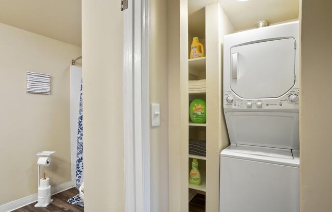 a laundry room with a washer and dryer and a closet