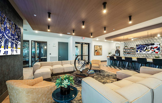 a living room with couches and chairs and a bar