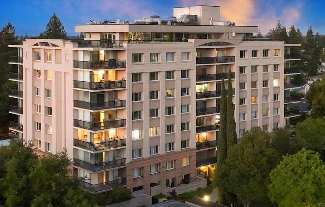 A large, modern apartment building with balconies and multiple stories.