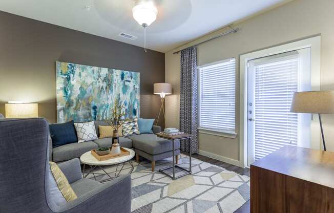 Model Living Room with Ceiling Fan and Patio/Balcony Entry