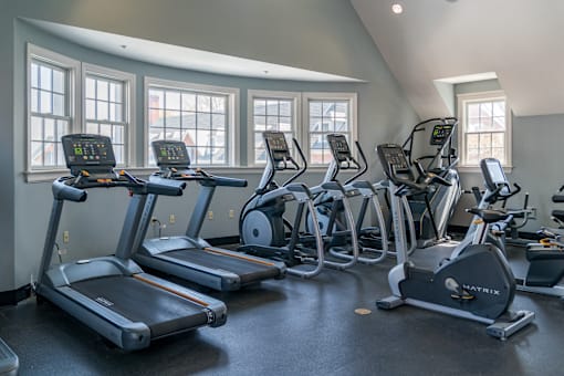 A gym with treadmills and elliptical machines.