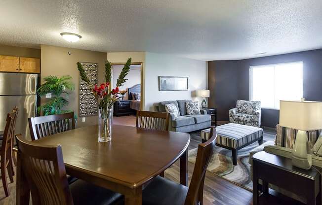 the view of a living room and dining room with a table and chairs