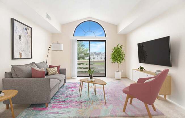 A living room with a cathedral ceiling and a slider to a balcony at North Pointe Apartments, Elkhart