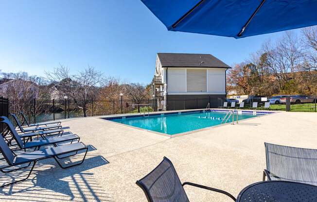 Pet-Friendly Apartments in Antioch, TN– Hickory Lake – A pool area with sun loungers and a building in the background.