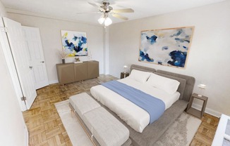 a bedroom with a bed and a ceiling fan