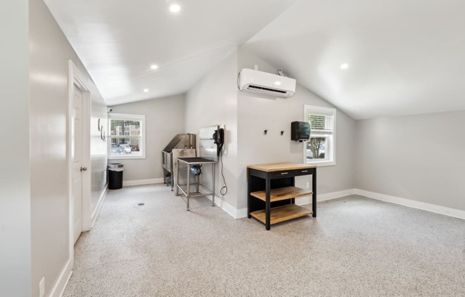 A room with a table and a window.