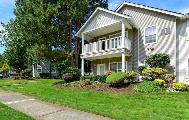 a house with a porch and a sidewalk in front of it