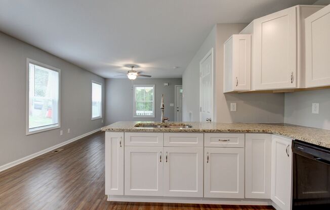 Two Story Duplex With Hardwood Flooring and White Cabinetry