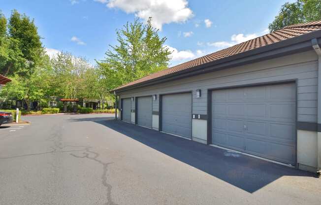 a large garage with a white garage door on the side of a house