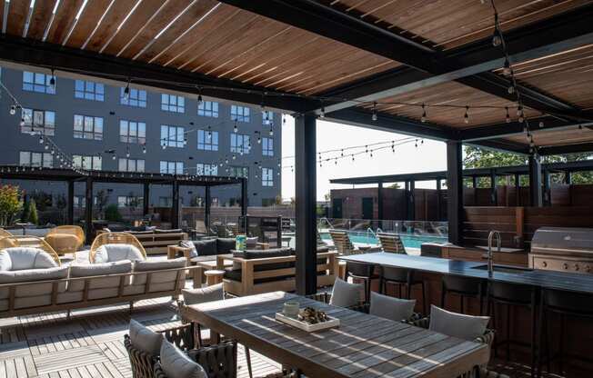 a rooftop patio with tables and chairs and a swimming pool