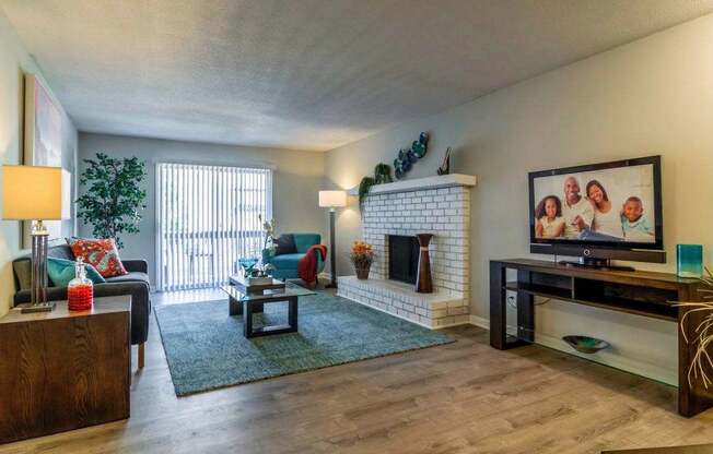 A living room with a fireplace and a television.