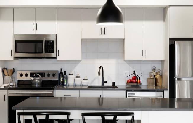 White Cabinetry With Sleek, Silver Appliances at The Hill Apartments, Saint Paul, Minnesota
