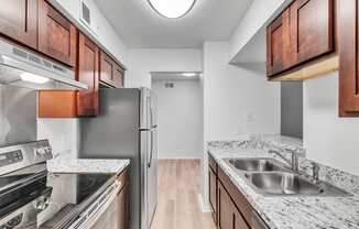 a kitchen with granite counter tops and stainless steel appliances