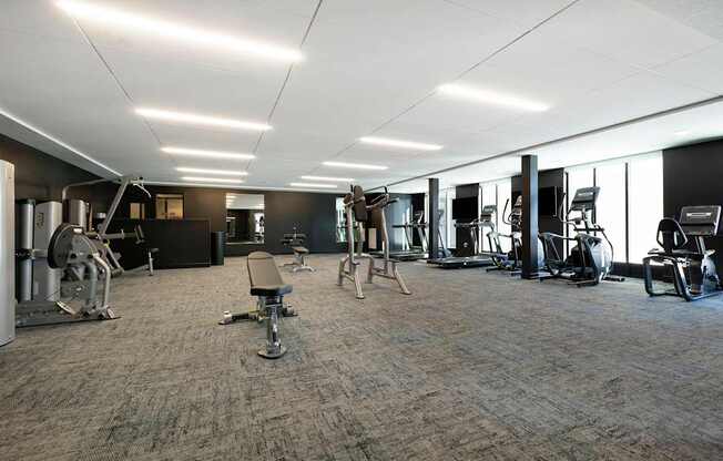 A spacious gym with a variety of equipment.