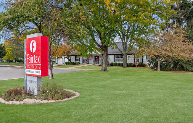 A sign for Fairfax Apartments stands in a grassy area.
