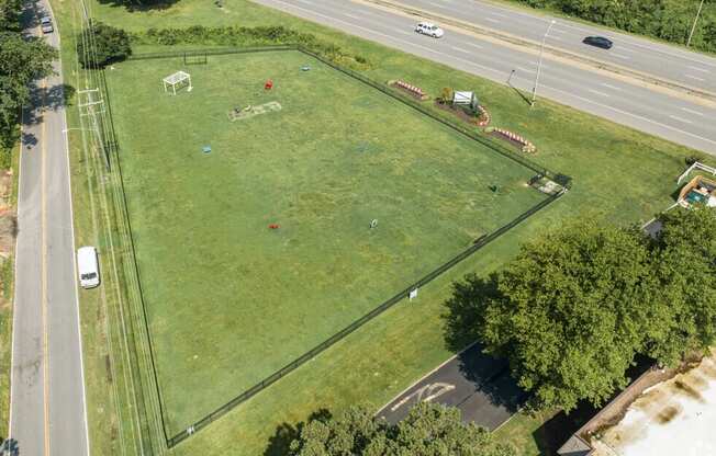 an aerial view of a green field next to a highway  at Bayville Apartments, Virginia