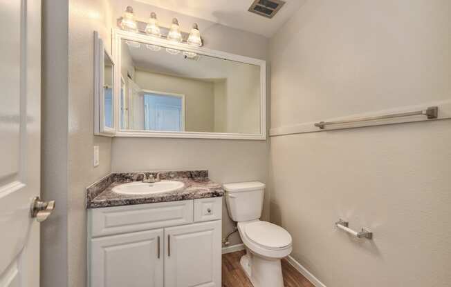 Two Bedroom Bathroom #1, white cabinetry and large mirror