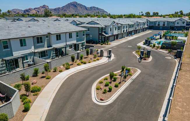 A residential area with houses and a road.