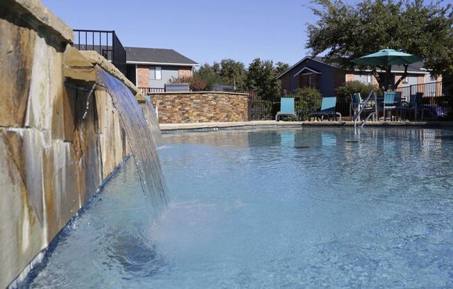 a large swimming pool with water coming out of it