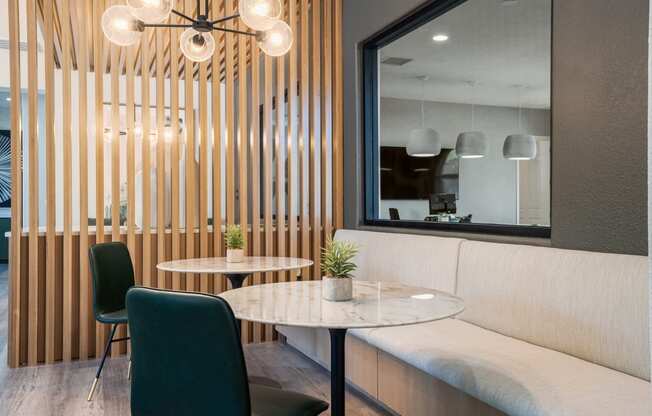 a small dining room with a marble table and two chairs