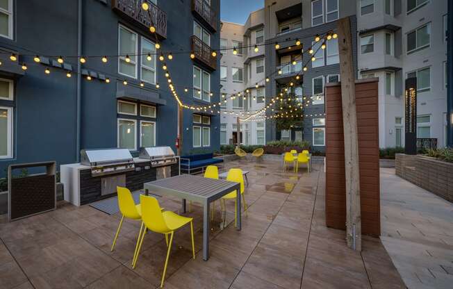 an outdoor patio with tables and chairs and string lights