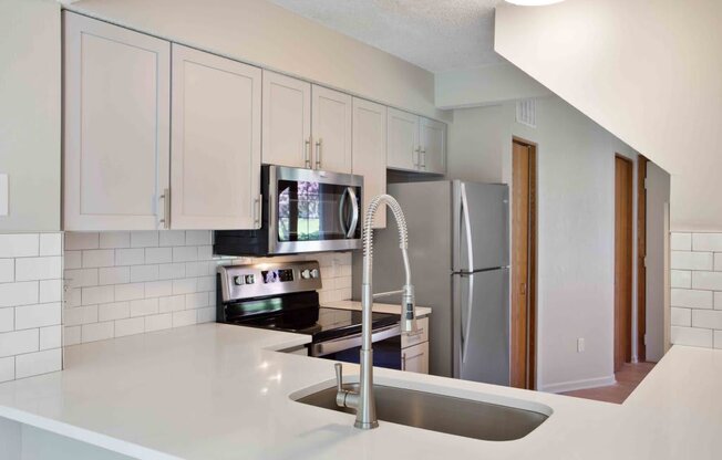 a kitchen with a sink and a refrigerator