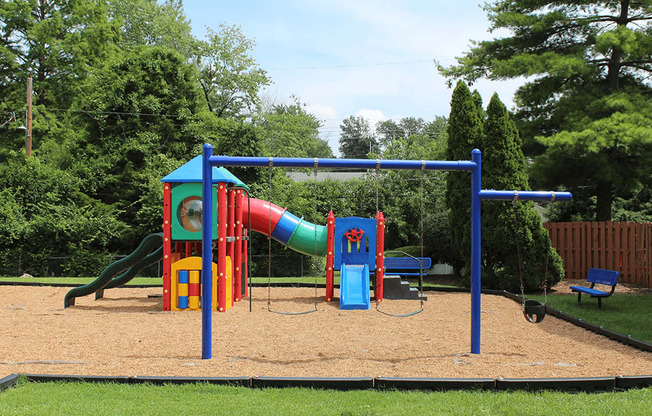 a playground with a slide and monkey bars in a park