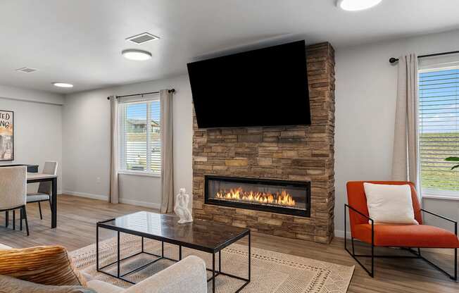 A modern living room with a fireplace and a flat screen TV mounted above it.