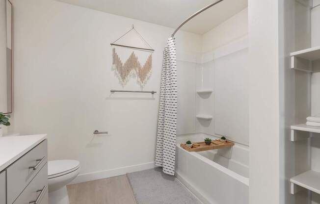 a bathroom with a shower and a toilet and a sink